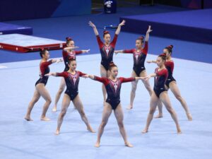 Collegiate gymnasts performing a routine at the University of Pennsylvania