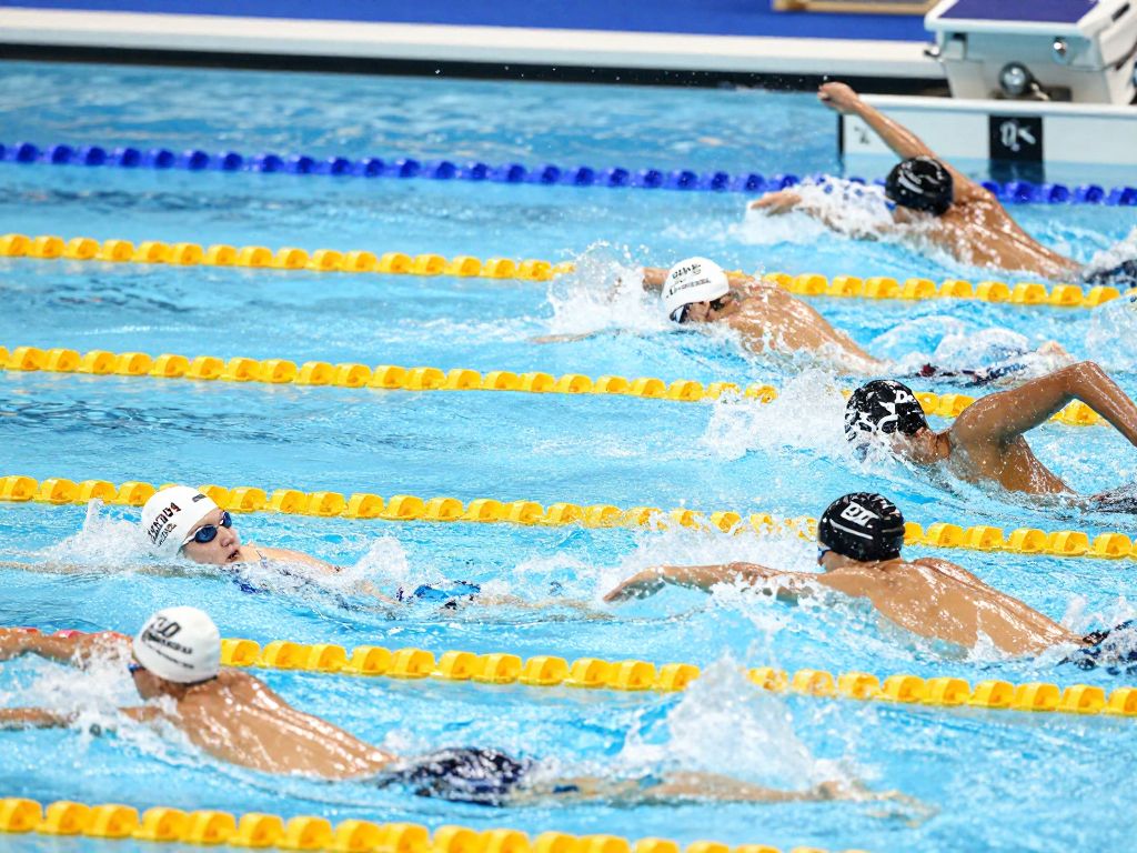 Diverse athletes competing in a swimming event