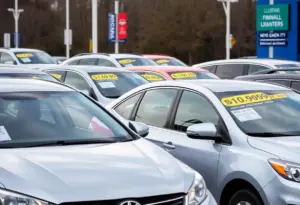 A view of a car dealership in Delaware County with various new cars displayed.