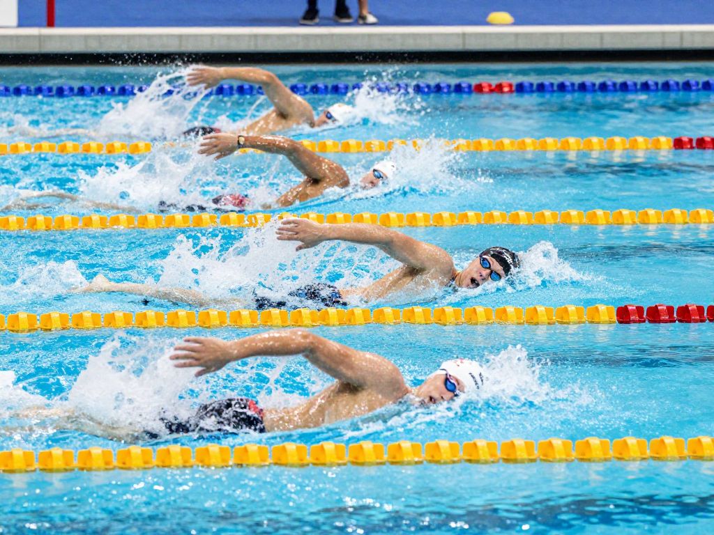 Harvard men's and women's swimming teams in action during a dual meet.