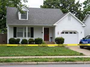 Police tape surrounding a suburban home in Northeast Philadelphia representing a crime scene.