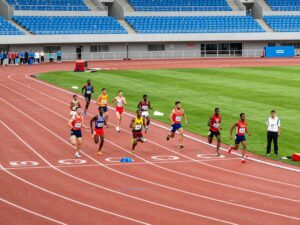 Athletes competing in a collegiate track and field event at the Penn Select meet.