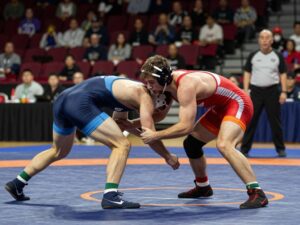 Wrestlers competing at the F&M Open, showcasing intense athleticism.