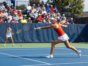 Players from Penn women's tennis team celebrating their victory during a match.